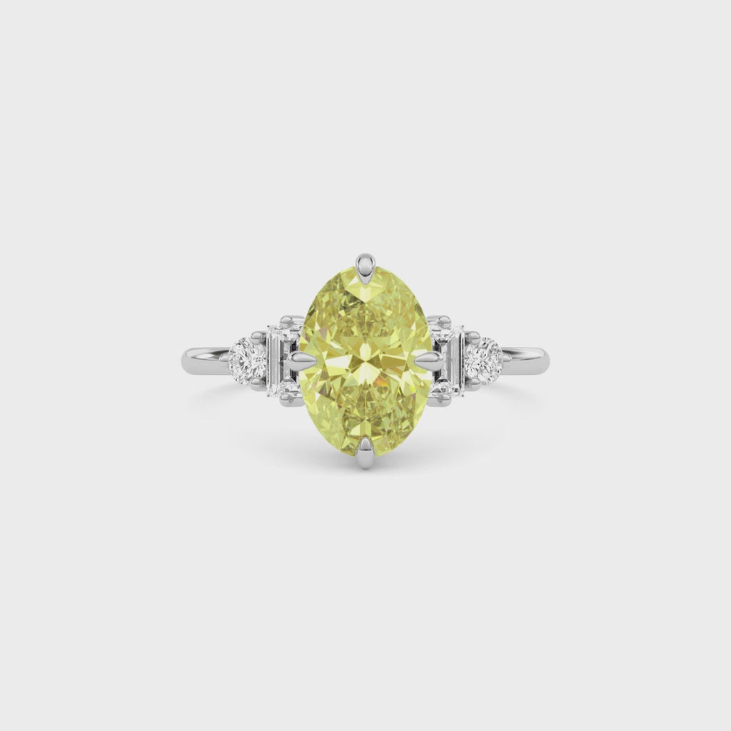 Yellow gold Fancy Yellow Oval Cut Three Stone Diamond Engagement Ring with Tapered Baguette and Round Side Stones