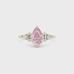 Yellow gold Fancy Pink Pear Cut Three Stone Diamond Engagement Ring with Tapered Baguette and Round Side Stones
