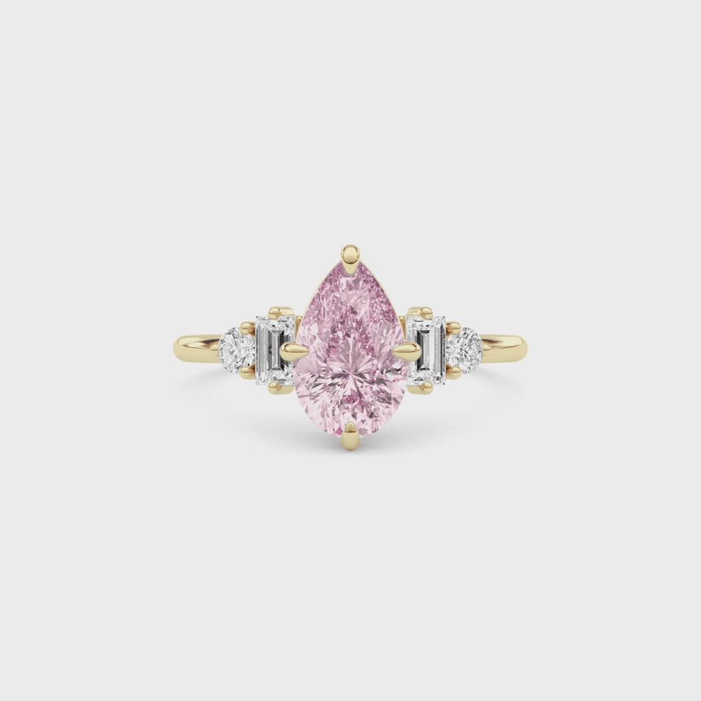 Yellow gold Fancy Pink Pear Cut Three Stone Diamond Engagement Ring with Tapered Baguette and Round Side Stones
