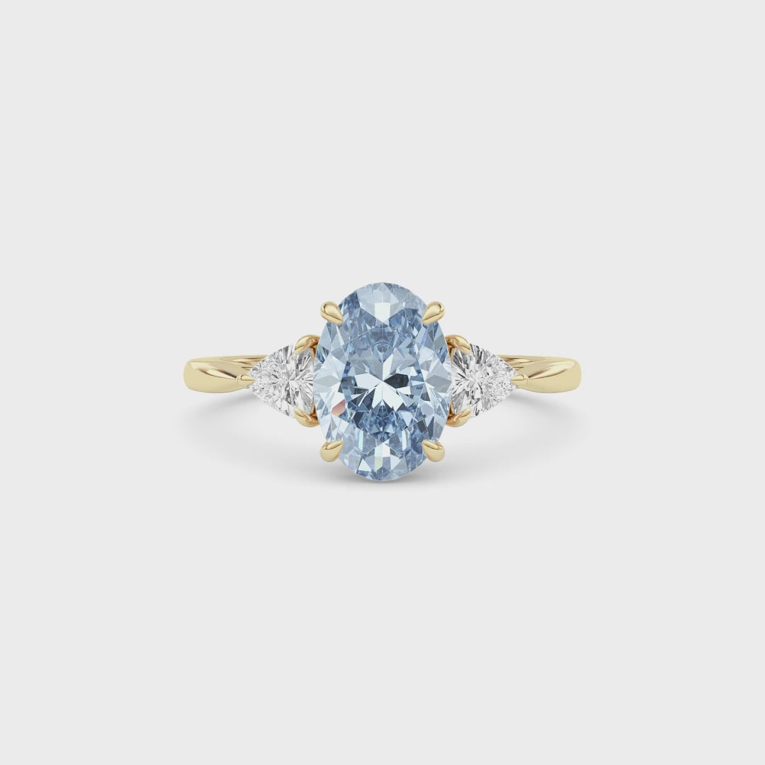 Yellow gold Three-Stone Fancy Blue Oval Cut Diamond Ring with Trillion Side Stones