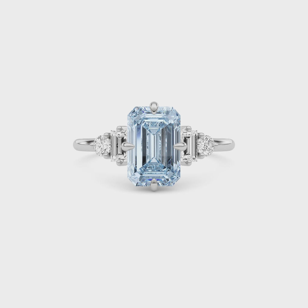 Platinum Three-Stone Fancy Blue Emerald Cut Diamond Ring with Heart Side Stones