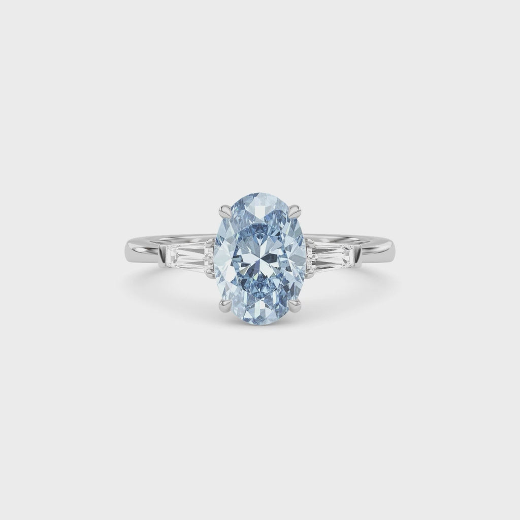 White gold Three-Stone Fancy Blue Oval Cut Diamond Ring with Tapered Baguette Side Stones
