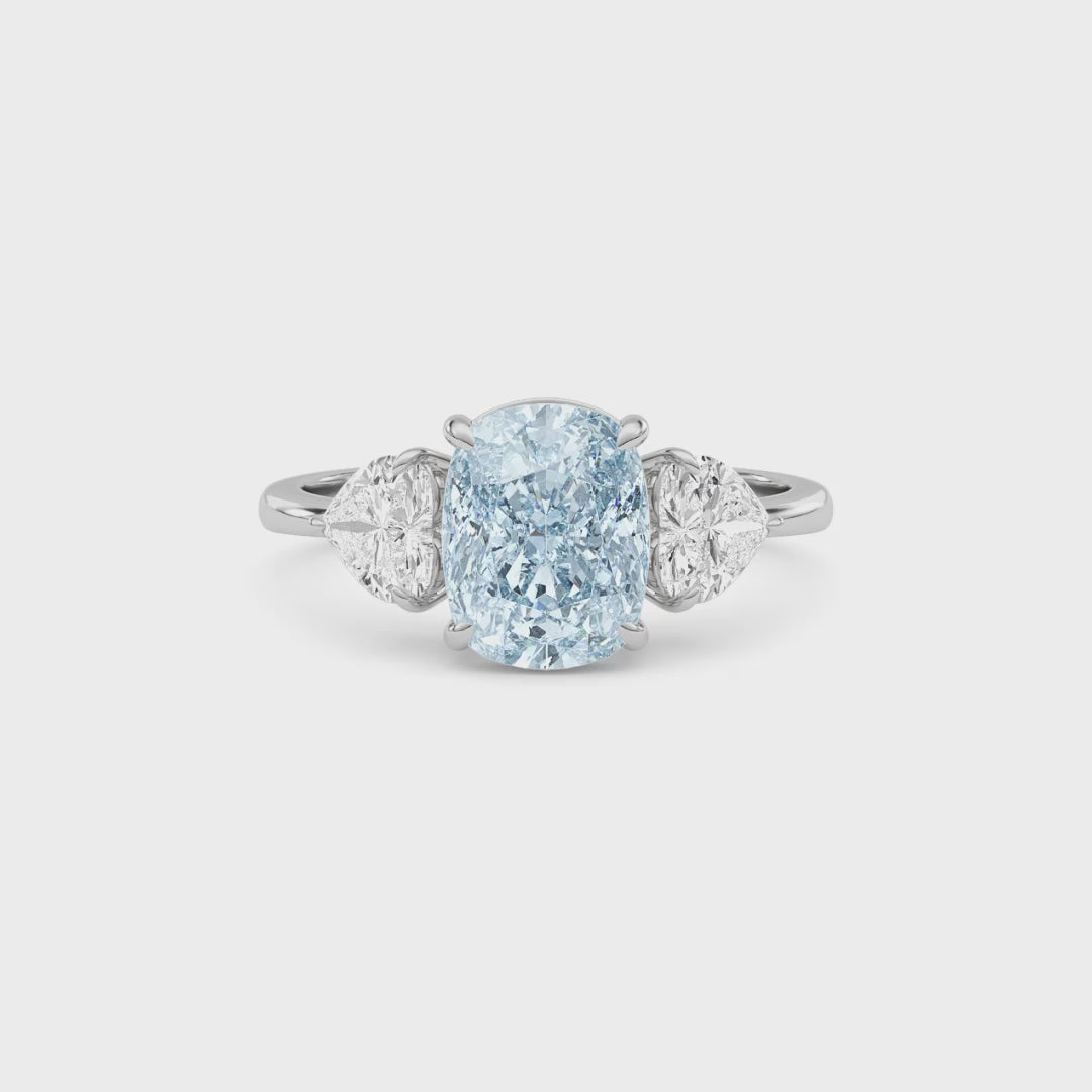 Platinum Three-Stone Fancy Blue Cushion Cut Diamond Ring with Heart Side Stones