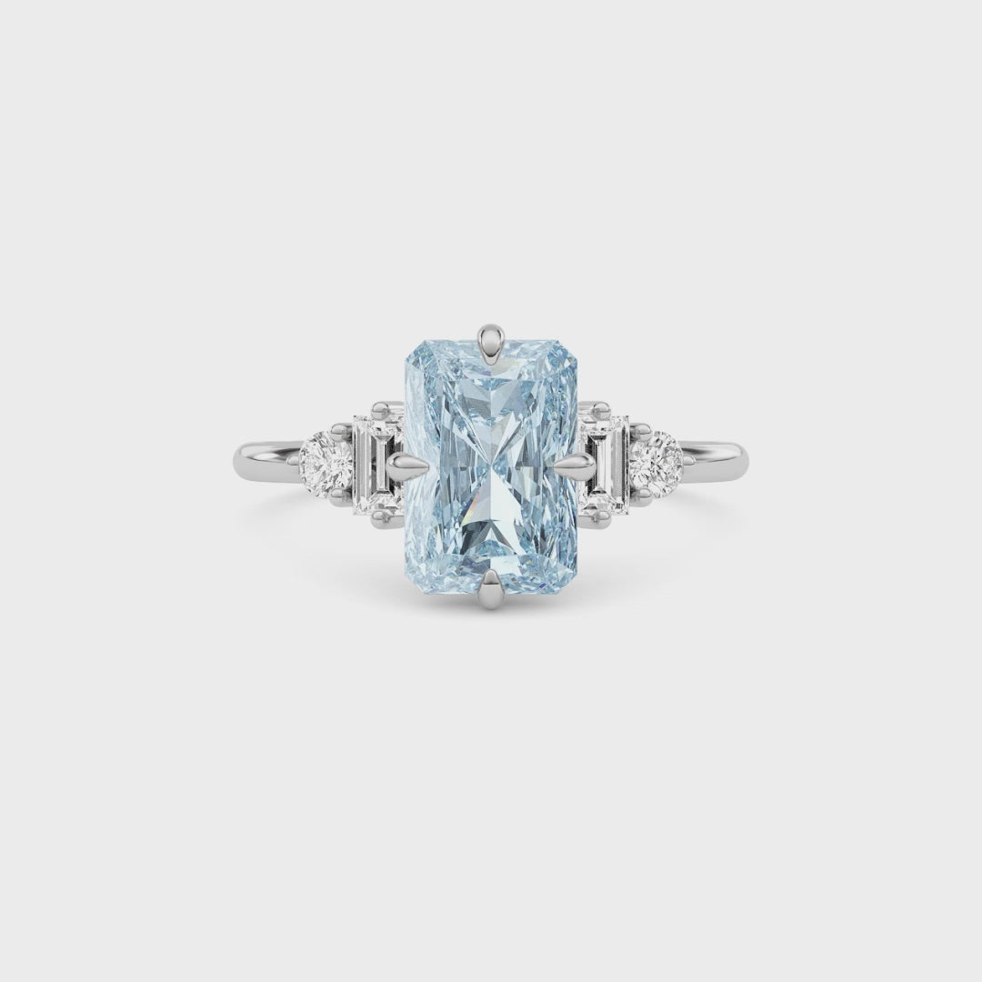 Platinum Three-Stone Fancy Blue Radiant Cut Diamond Ring with Heart Side Stones