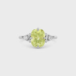 Yellow gold Fancy Yellow Cushion Cut Three Stone Diamond Engagement Ring with Tapered Baguette and Round Side Stones