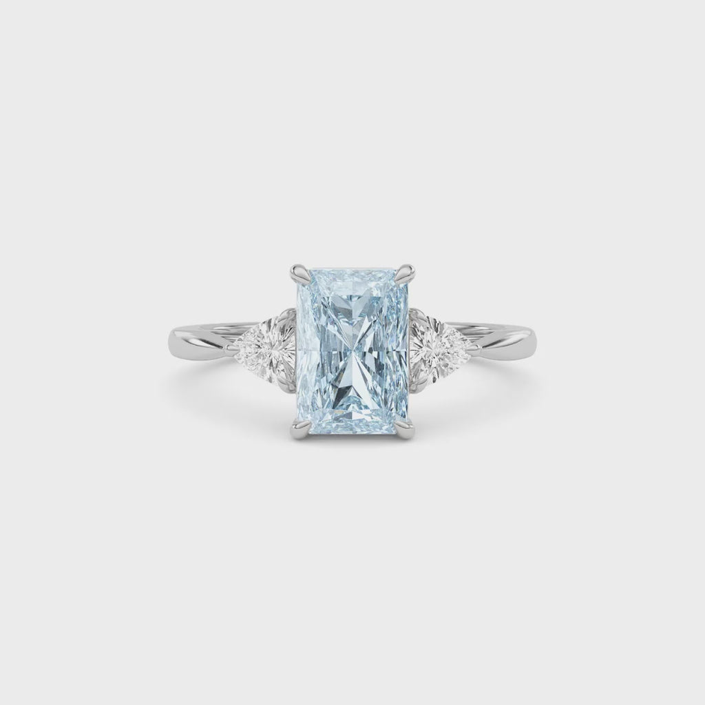Silver Three-Stone Fancy Blue Radiant Cut Diamond Ring with Trillion Side Stones