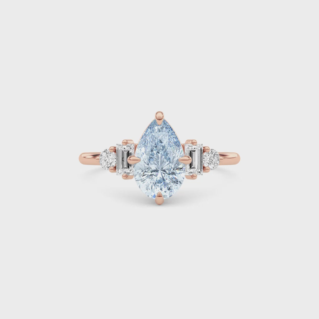 Rose gold Fancy Blue Pear Cut Three Stone Diamond Engagement Ring with Tapered Baguette and Round Side Stones