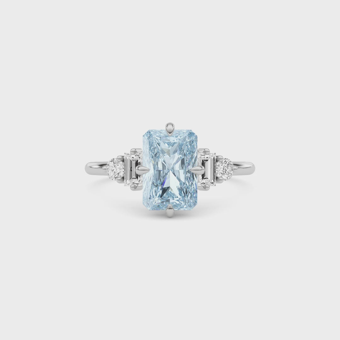 White gold Fancy Blue Radiant Cut Three Stone Diamond Engagement Ring with Tapered Baguette and Round Side Stones