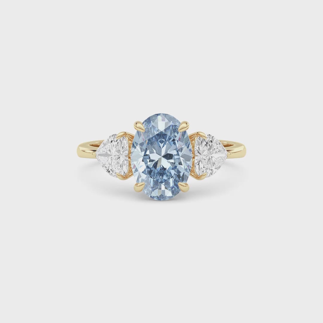Yellow gold Three-Stone Fancy Blue Oval Cut Diamond Ring with Heart Side Stones