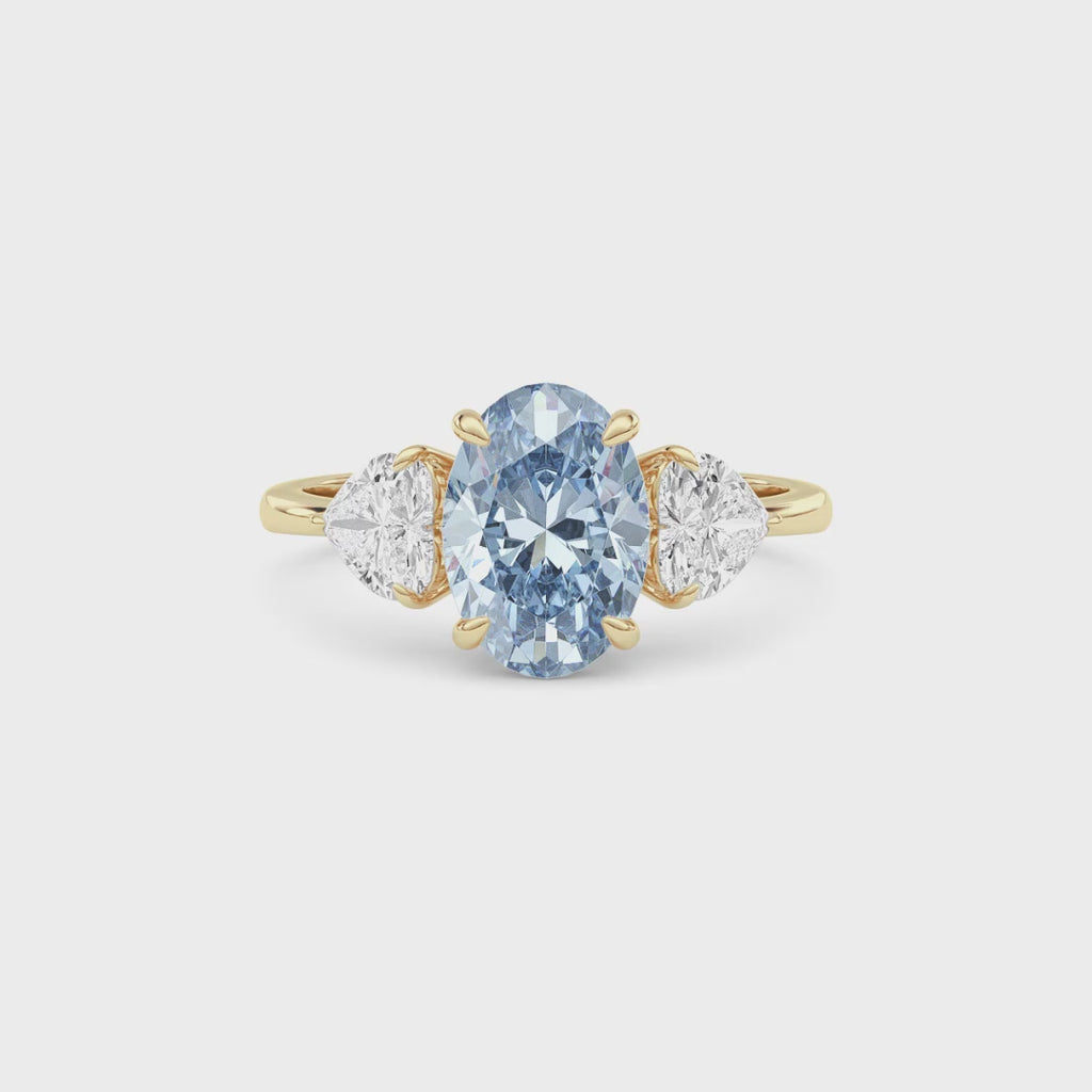 Yellow gold Three-Stone Fancy Blue Oval Cut Diamond Ring with Heart Side Stones
