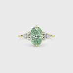 Yellow gold Fancy Green Oval Cut Three Stone Diamond Engagement Ring with Tapered Baguette and Round Side Stones