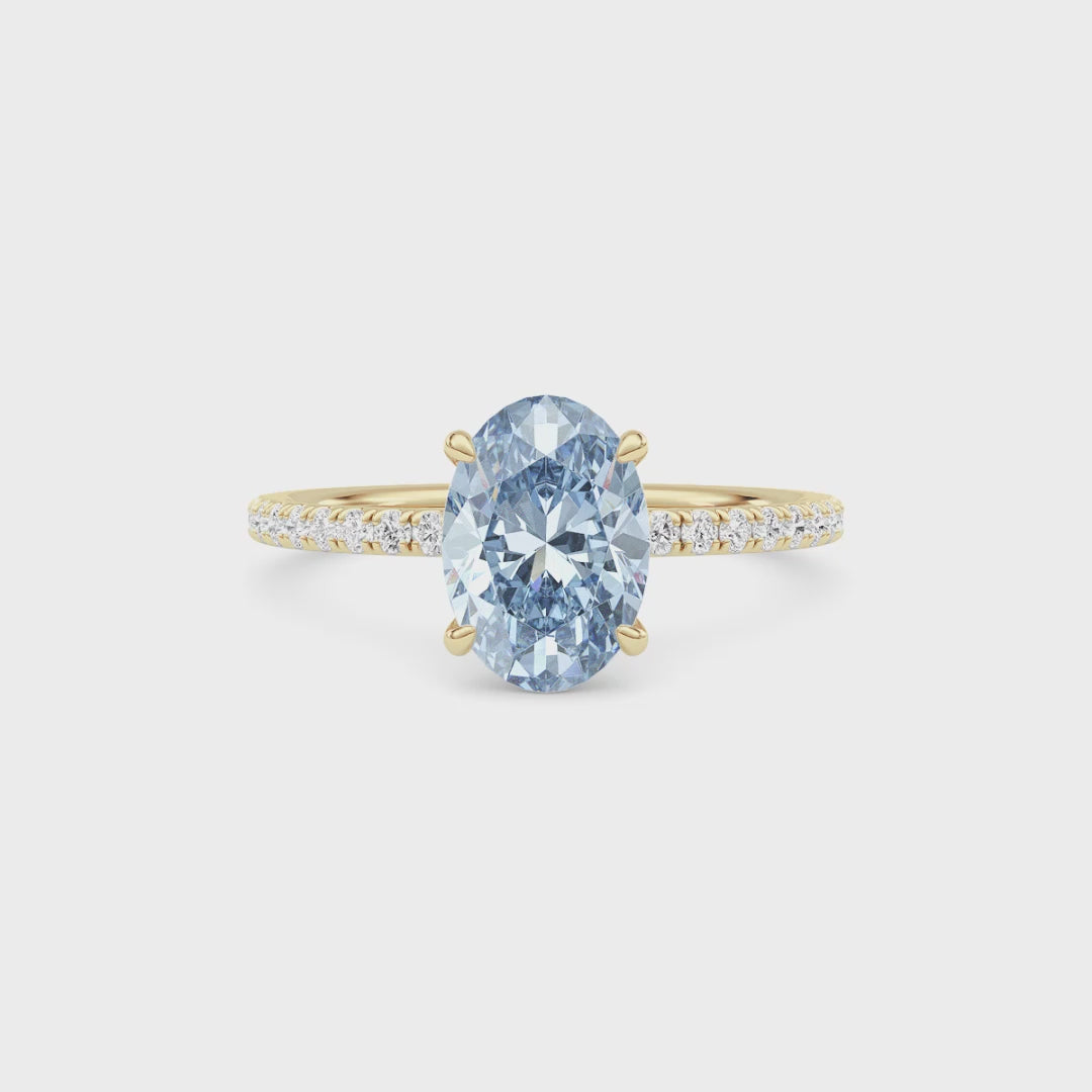 Yellow gold Fancy Blue Oval Cut Diamond Solitaire with Pavé Band