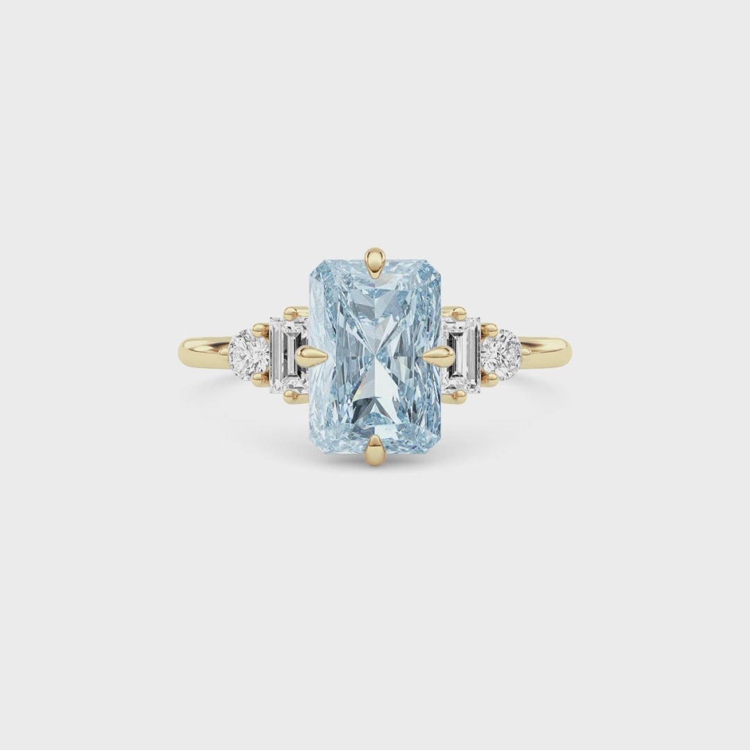 Yellow gold Three-Stone Fancy Blue Radiant Cut Diamond Ring with Heart Side Stones