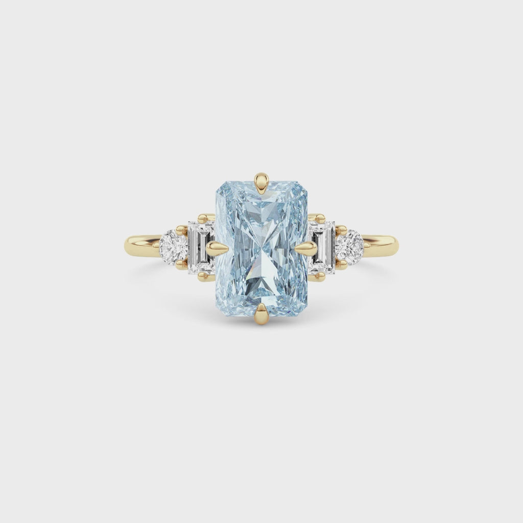 Yellow gold Three-Stone Fancy Blue Radiant Cut Diamond Ring with Heart Side Stones