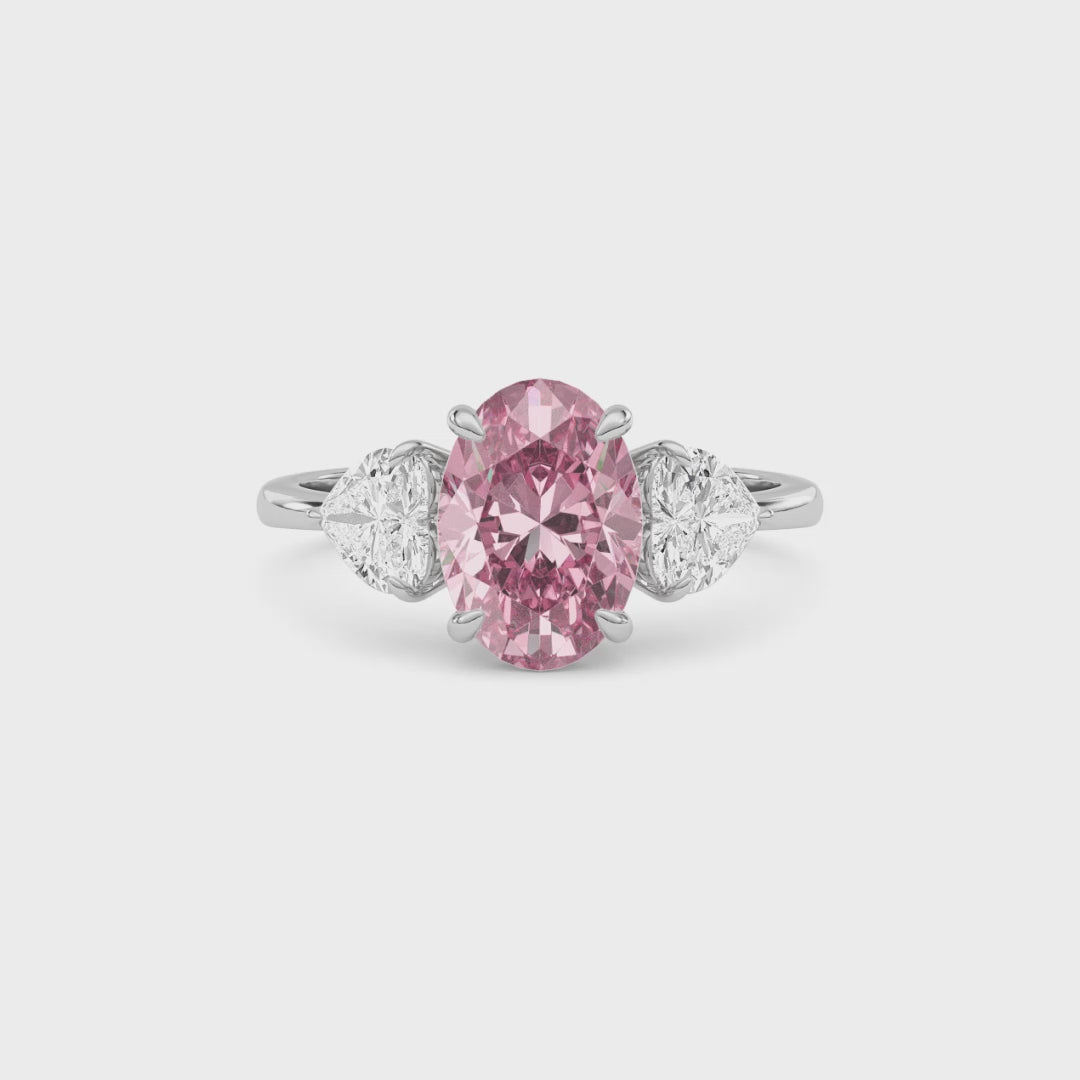 Platinum Three-Stone Fancy Pink Oval Cut Diamond Ring with Heart Side Stones