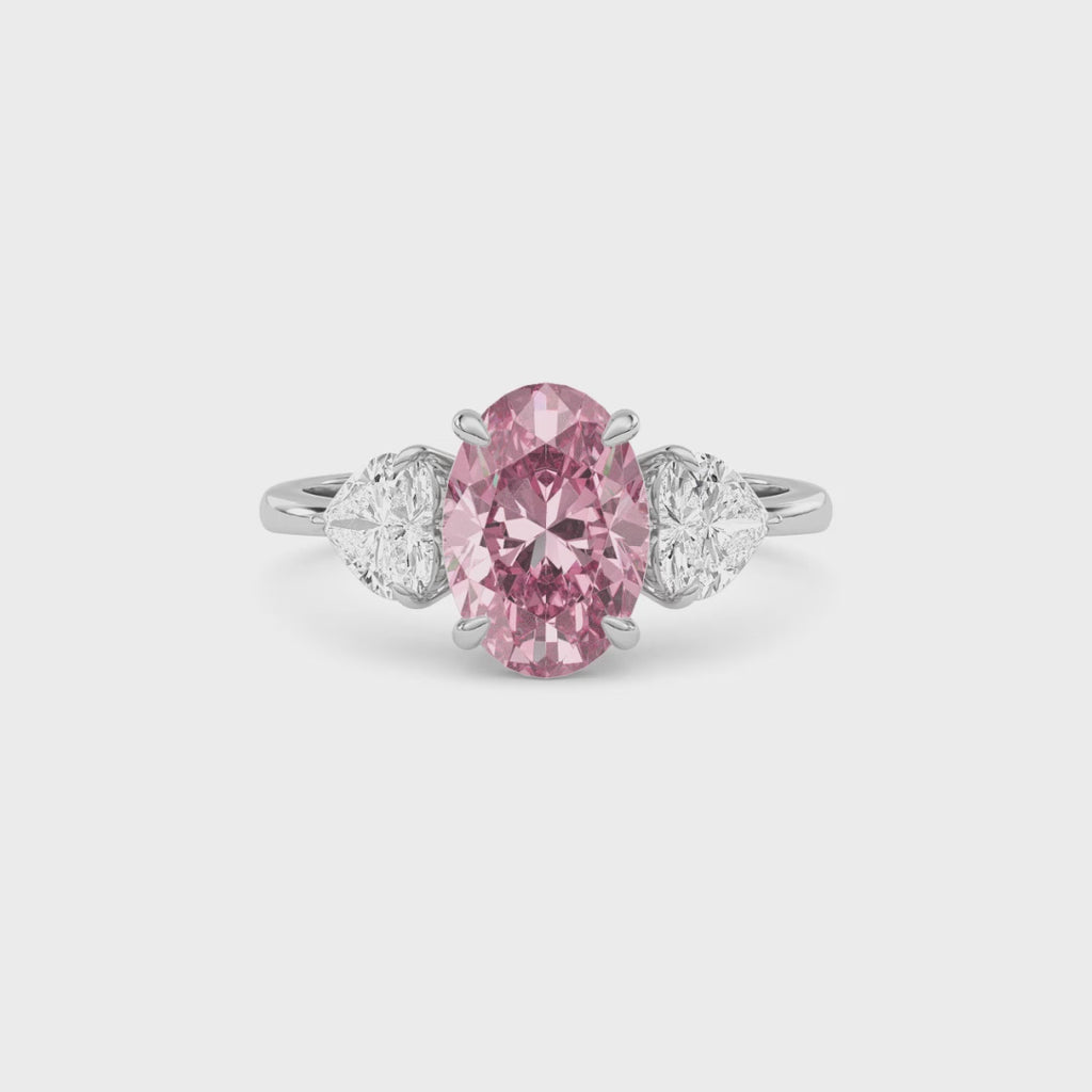 Platinum Three-Stone Fancy Pink Oval Cut Diamond Ring with Heart Side Stones