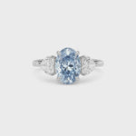 Platinum Three-Stone Fancy Blue Oval Cut Diamond Ring with Heart Side Stones