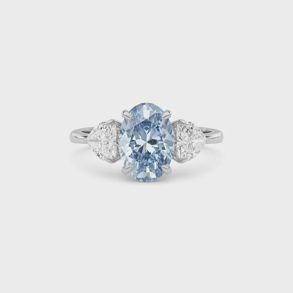 Platinum Three-Stone Fancy Blue Oval Cut Diamond Ring with Heart Side Stones