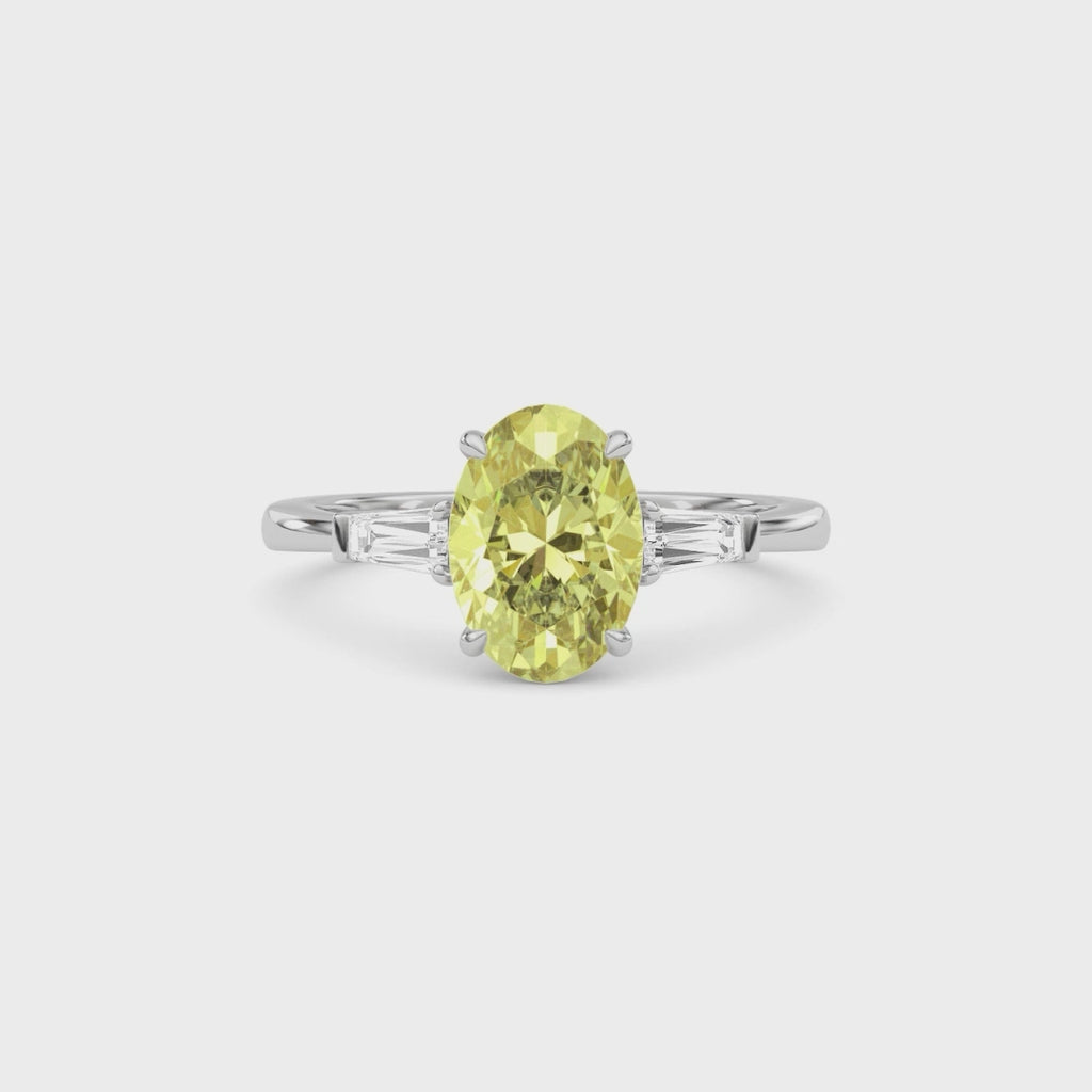 Yellow gold Three-Stone Fancy Yellow Oval Cut Diamond Ring with Tapered Baguette Side Stones