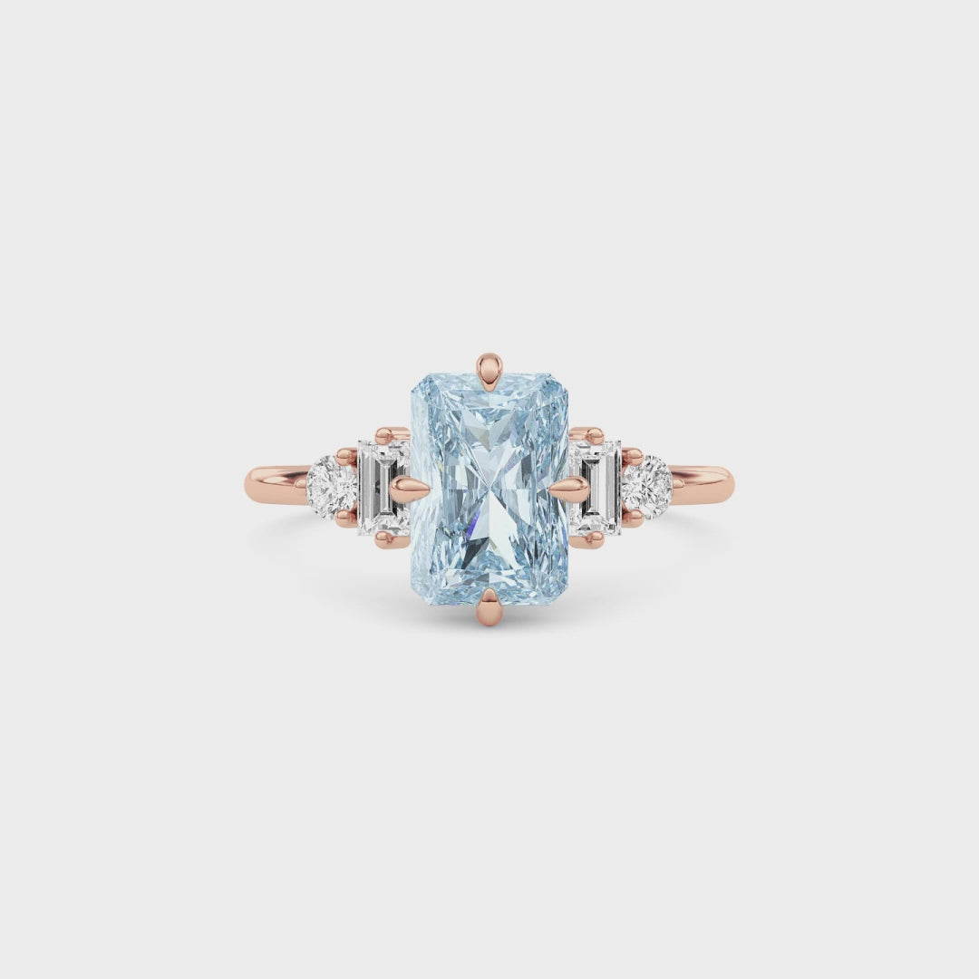 Rose gold Fancy Blue Radiant Cut Three Stone Diamond Engagement Ring with Tapered Baguette and Round Side Stones